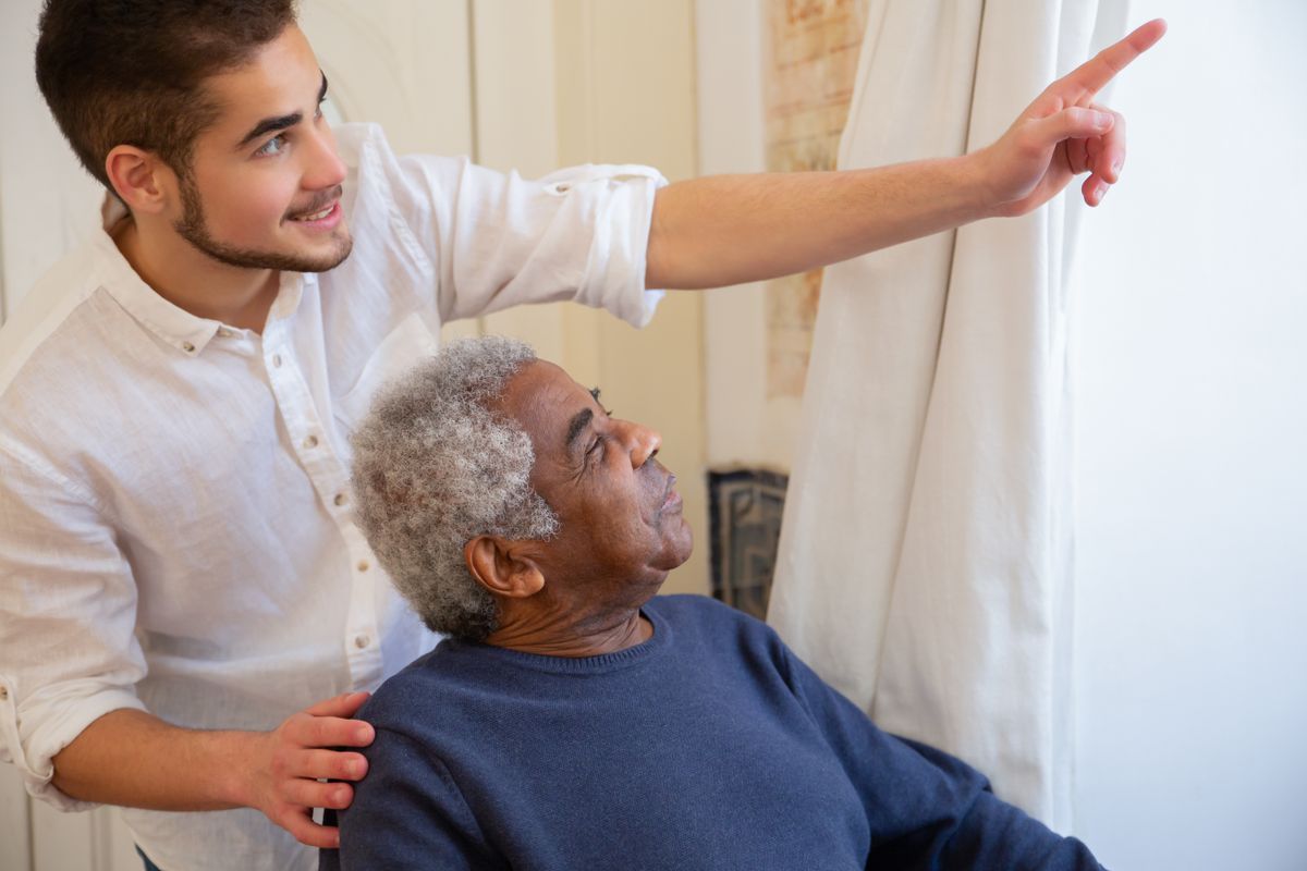 An older man spending time with a younger family caregiver at home